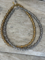 a stainless steel necklace in a stretchy spiral design resembling an olive wreath. designd and made in Greece. Waterproof and tarnish proof. perfect to wear from day to night.  adjustable and stretchy and would suit all