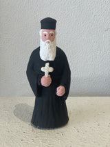 Priest Figurine holding White Cross