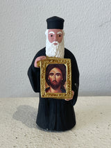 Priest Figurine holding Picture of Jesus